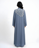 Back view of the Blue Mawjah Abaya featuring crystal and pearl artwork detail