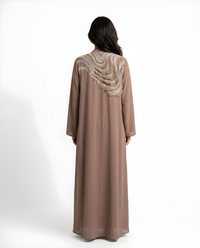 Side view of the Mocha Mawjah Abaya showing fit and drape in Dujalail fabric