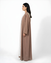 Side view of the Mocha Mawjah Abaya showing fit and drape in Dujalail fabric